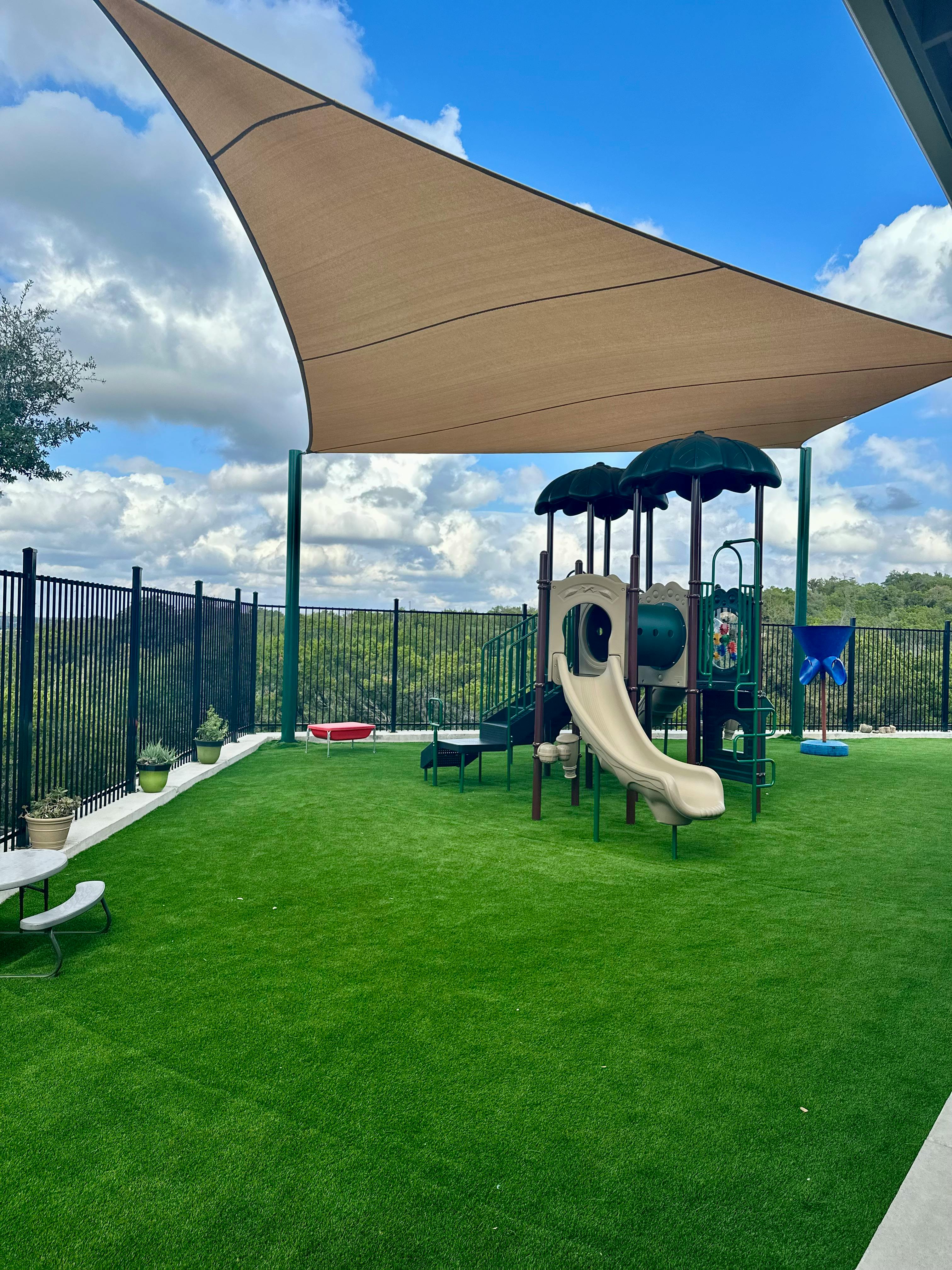 Playground with artificial turf and shade sail