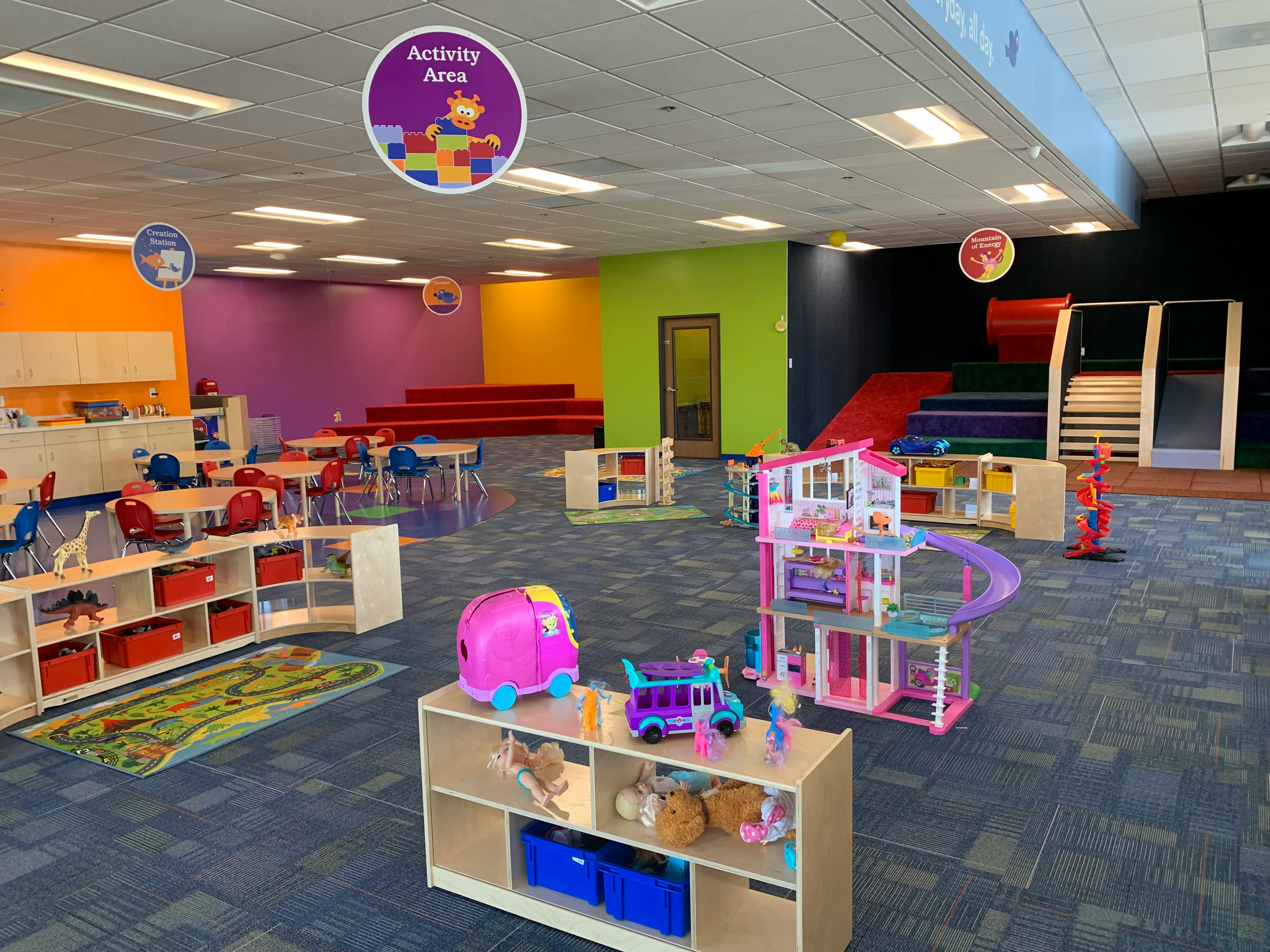 Playroom with colorful walls, play structures, and toys