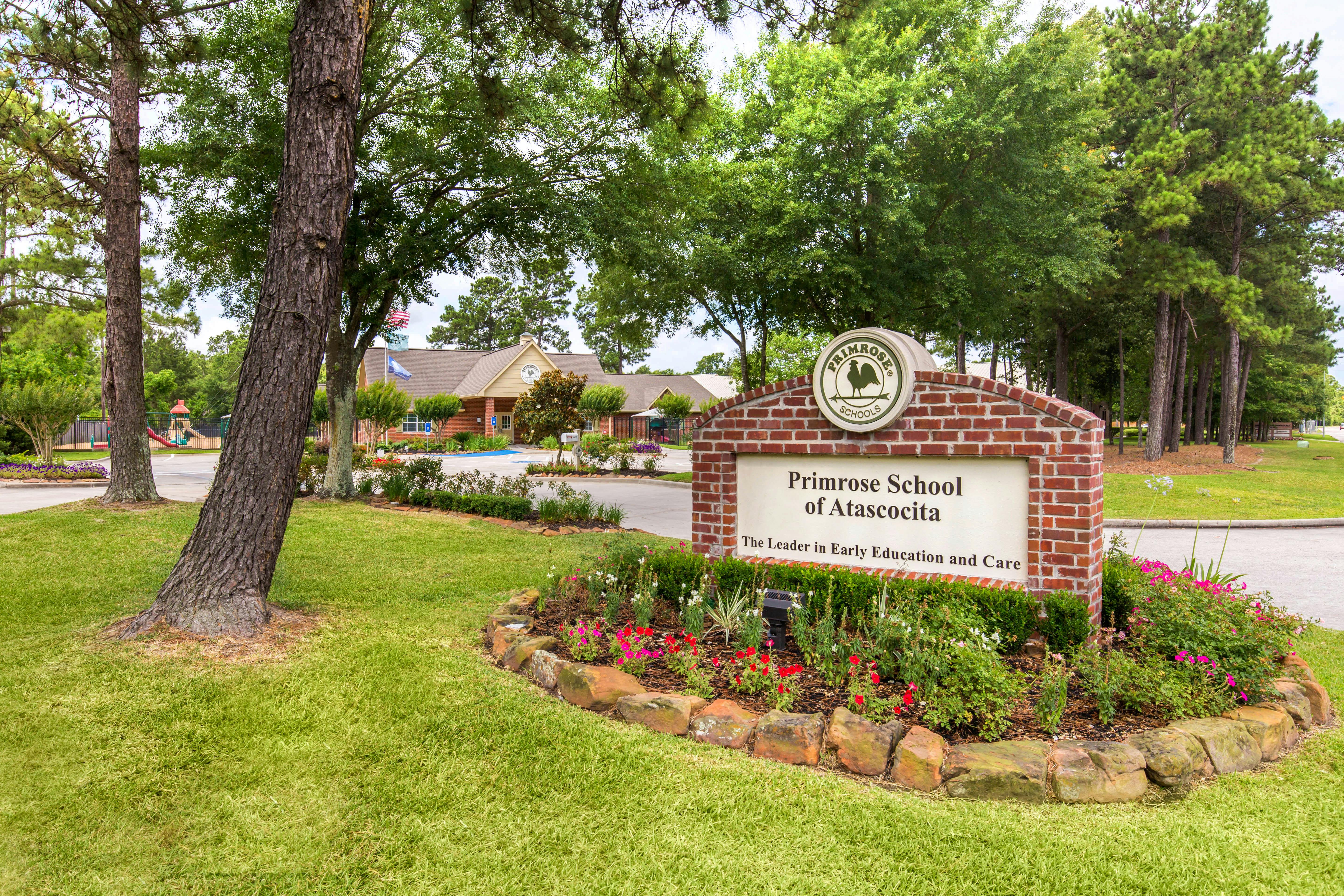 Primrose School of Atascocita sign in front of a school building with trees