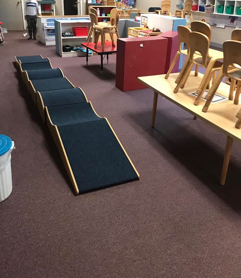 Indoor play equipment with ramps and steps in a classroom