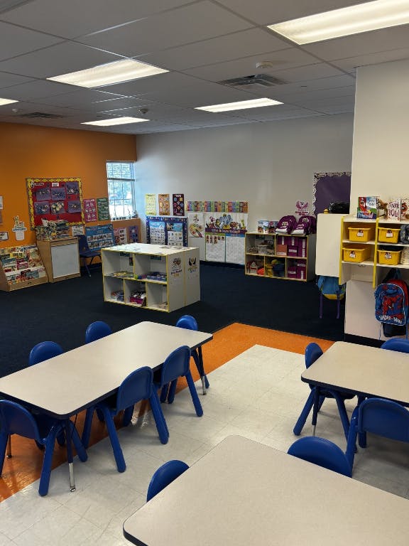 Empty classroom with small tables and chairs