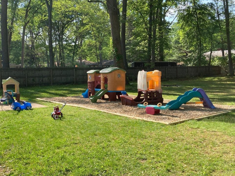 Outdoor playground with slides and play structures on wood chips