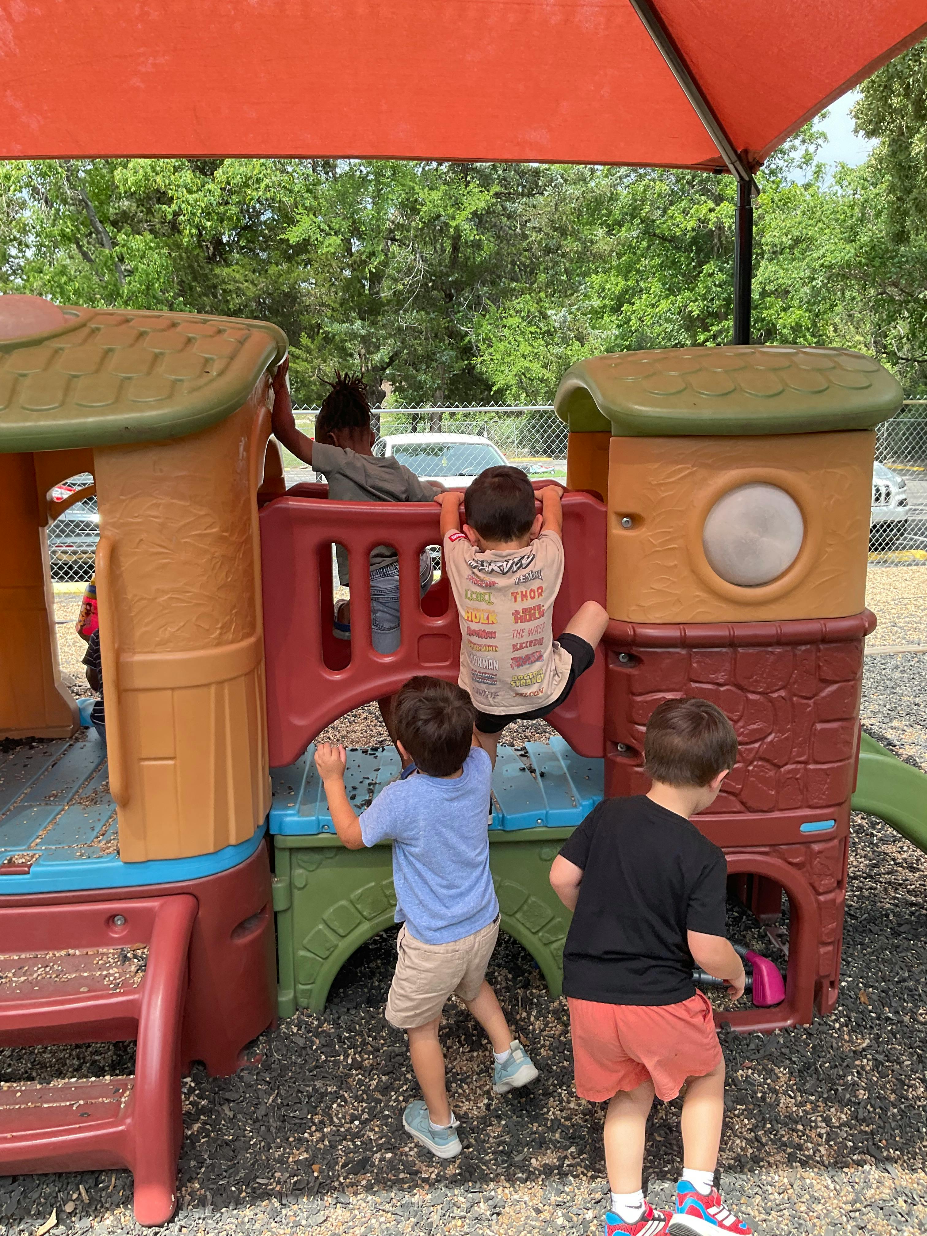Children playing on a colorful playground structure