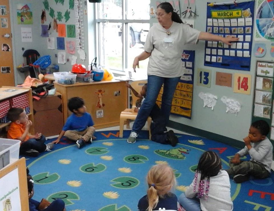 Person teaching children in a classroom