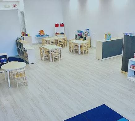 Empty classroom with small tables and chairs
