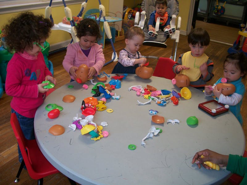 Children playing with toys at a round table