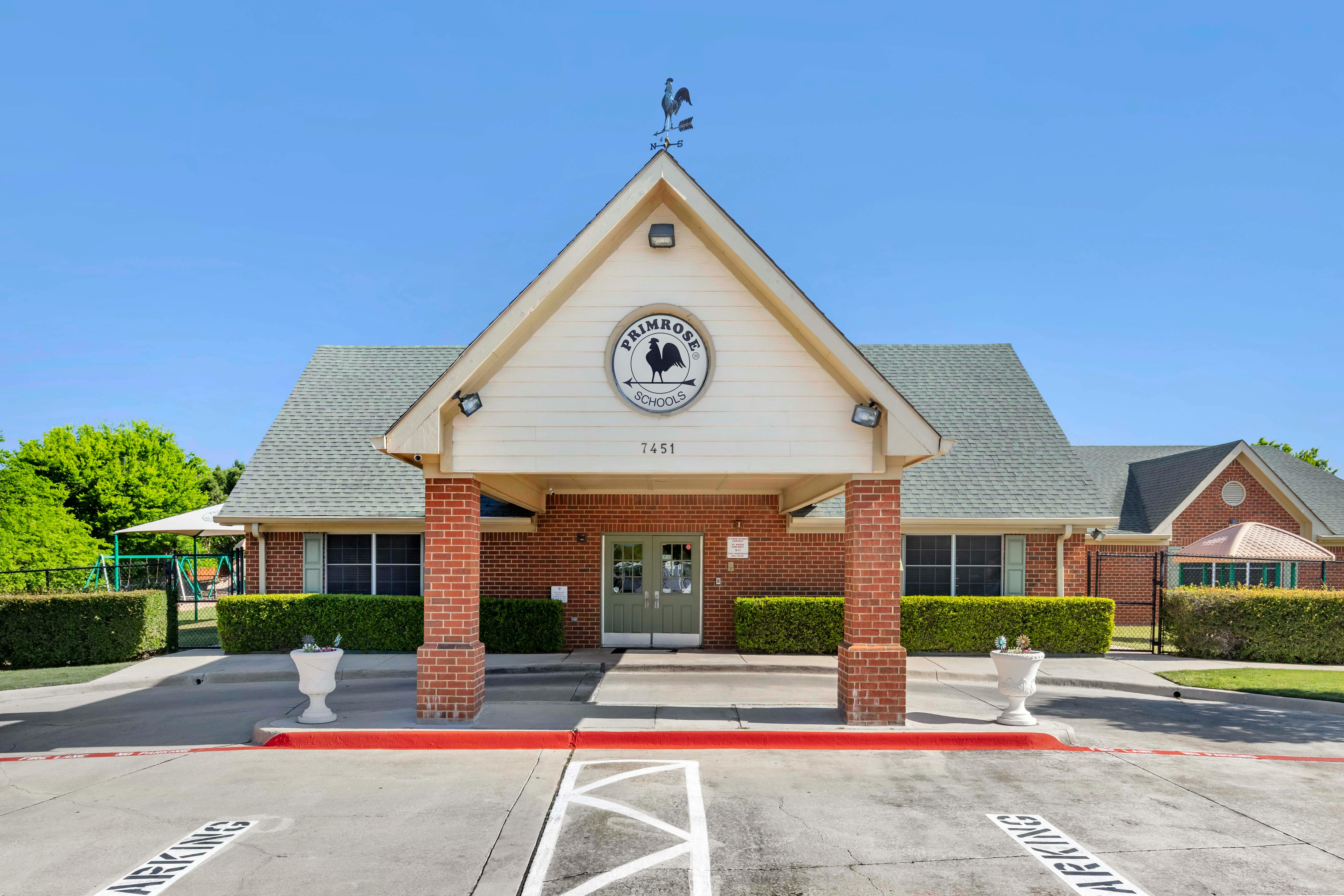 Front exterior of a Primrose Schools building with a rooster weathervane