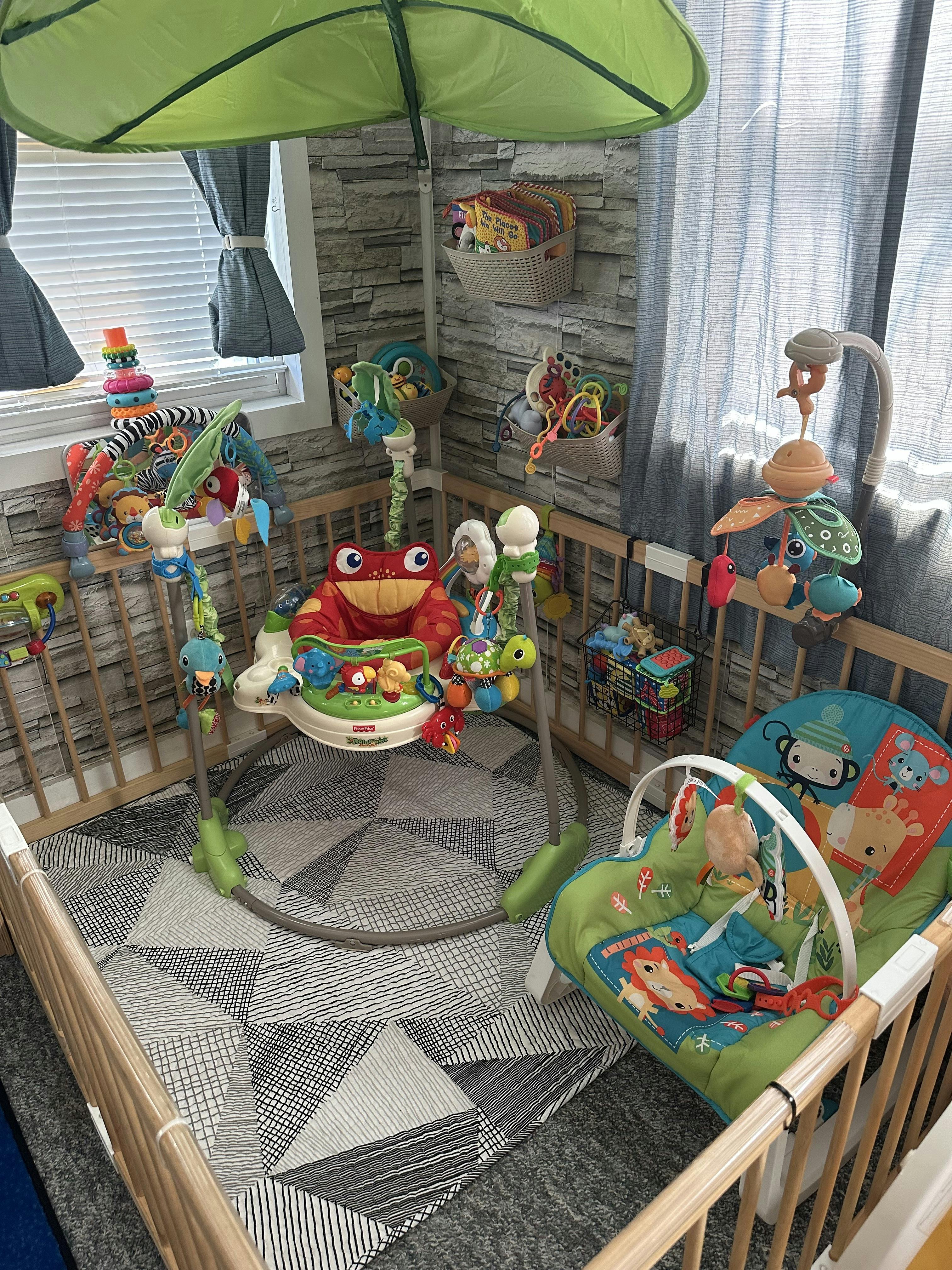 Baby bouncer and infant seat inside a playpen