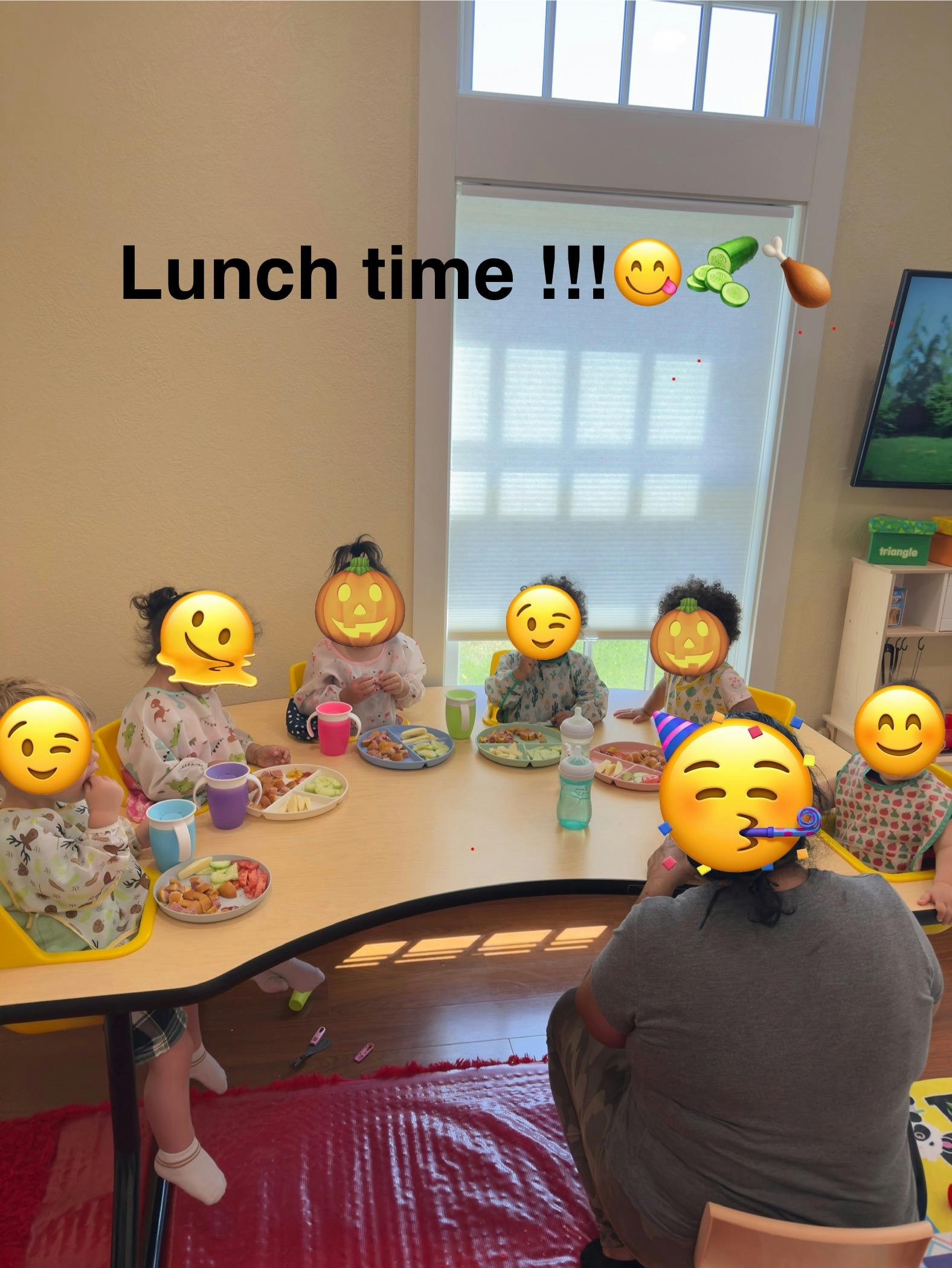 Children sitting at a table with plates of food
