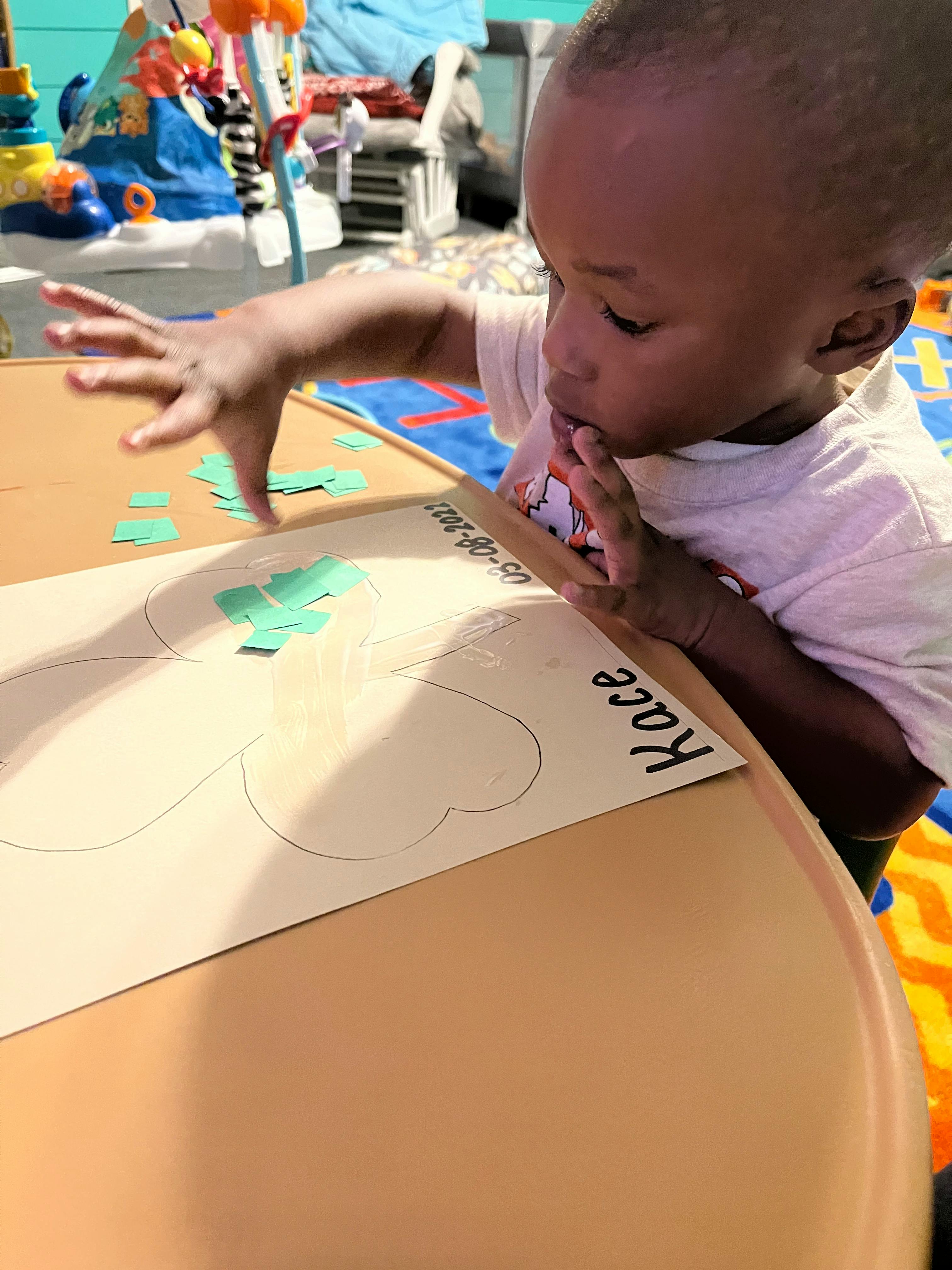 Child working on a craft project at a table