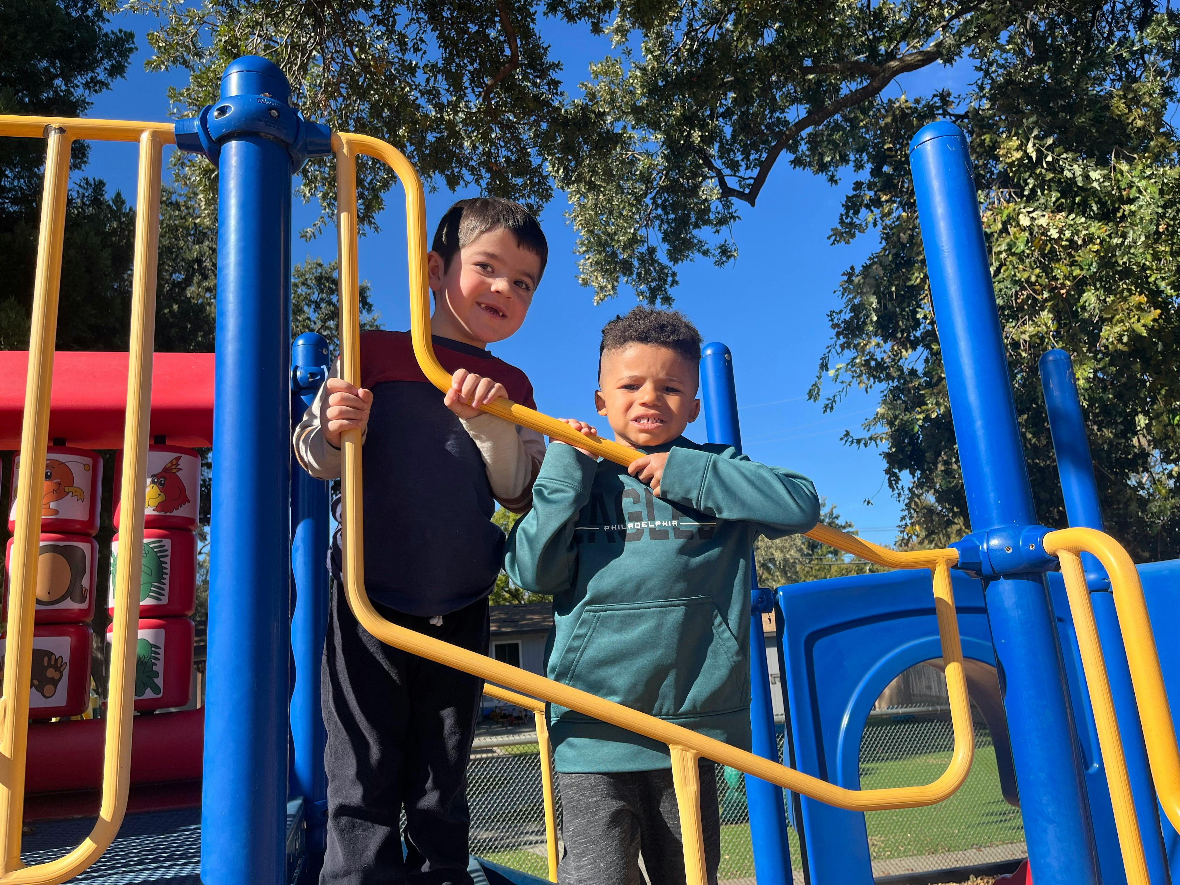 Two children on a playground structure