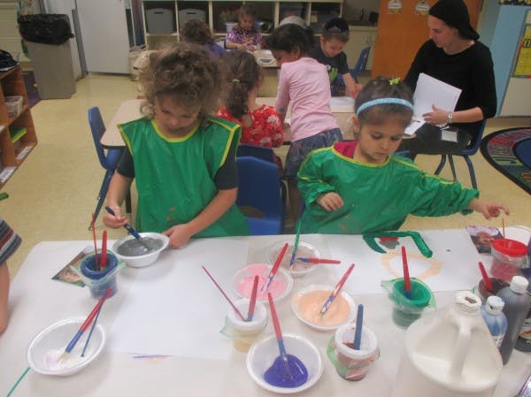 Children painting in a classroom