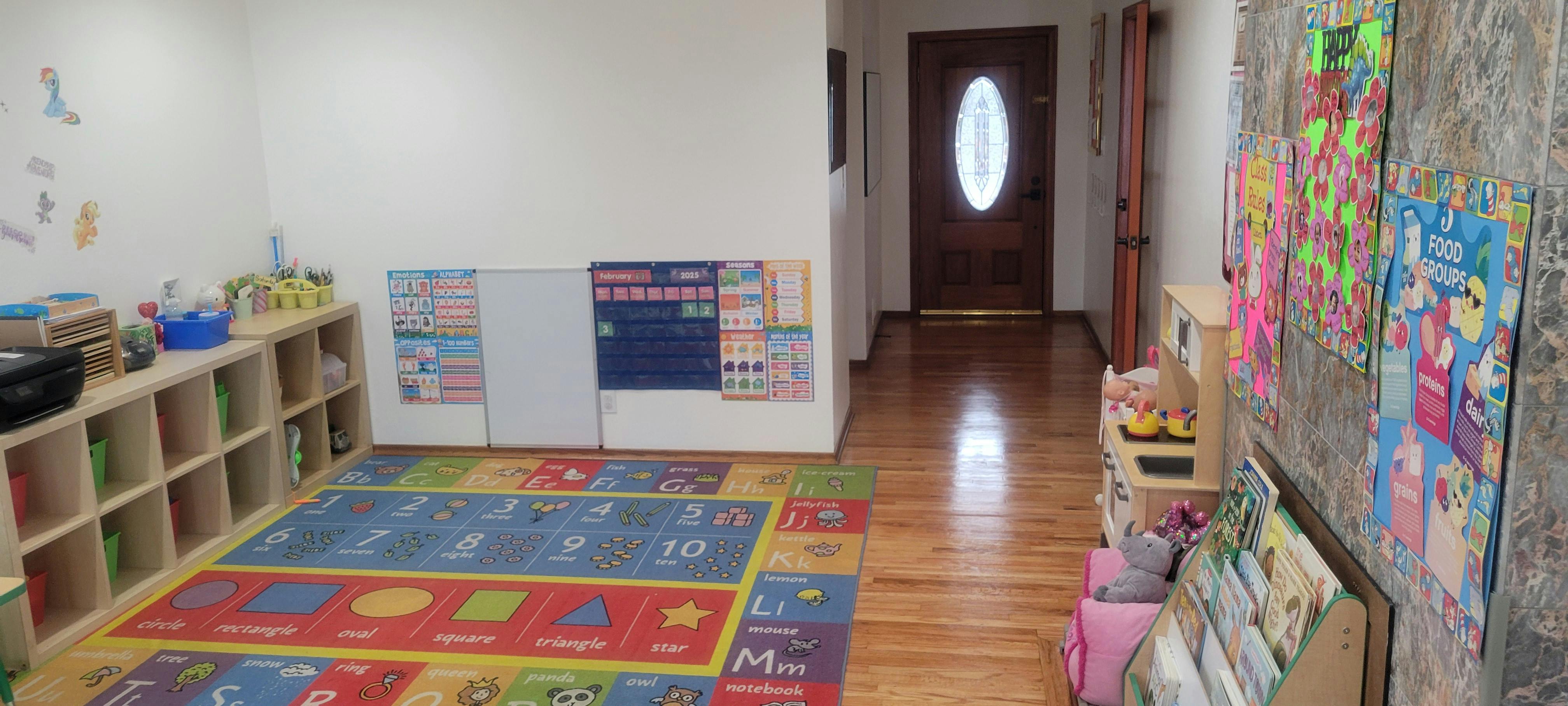 Playroom with colorful rug, shelves, and posters on the wall