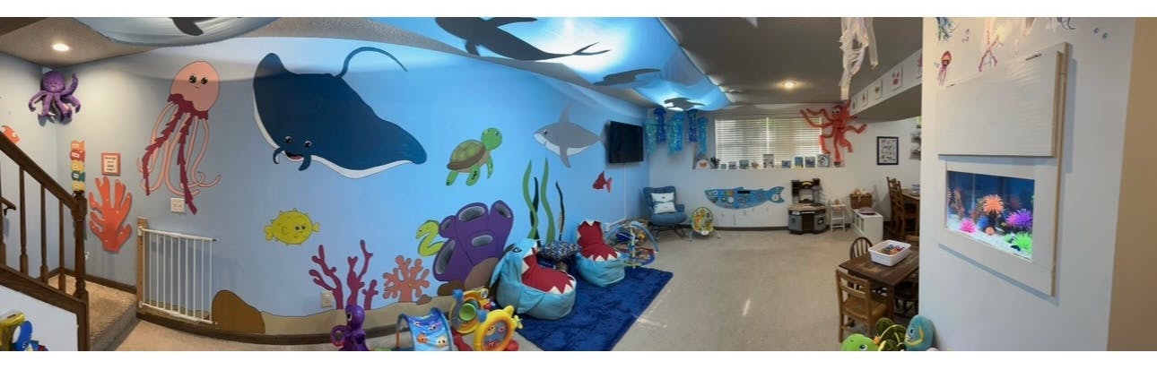 Room with ocean-themed murals and decor