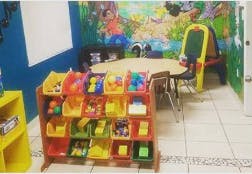 Toy organizer with colorful bins in a room with a table and chairs