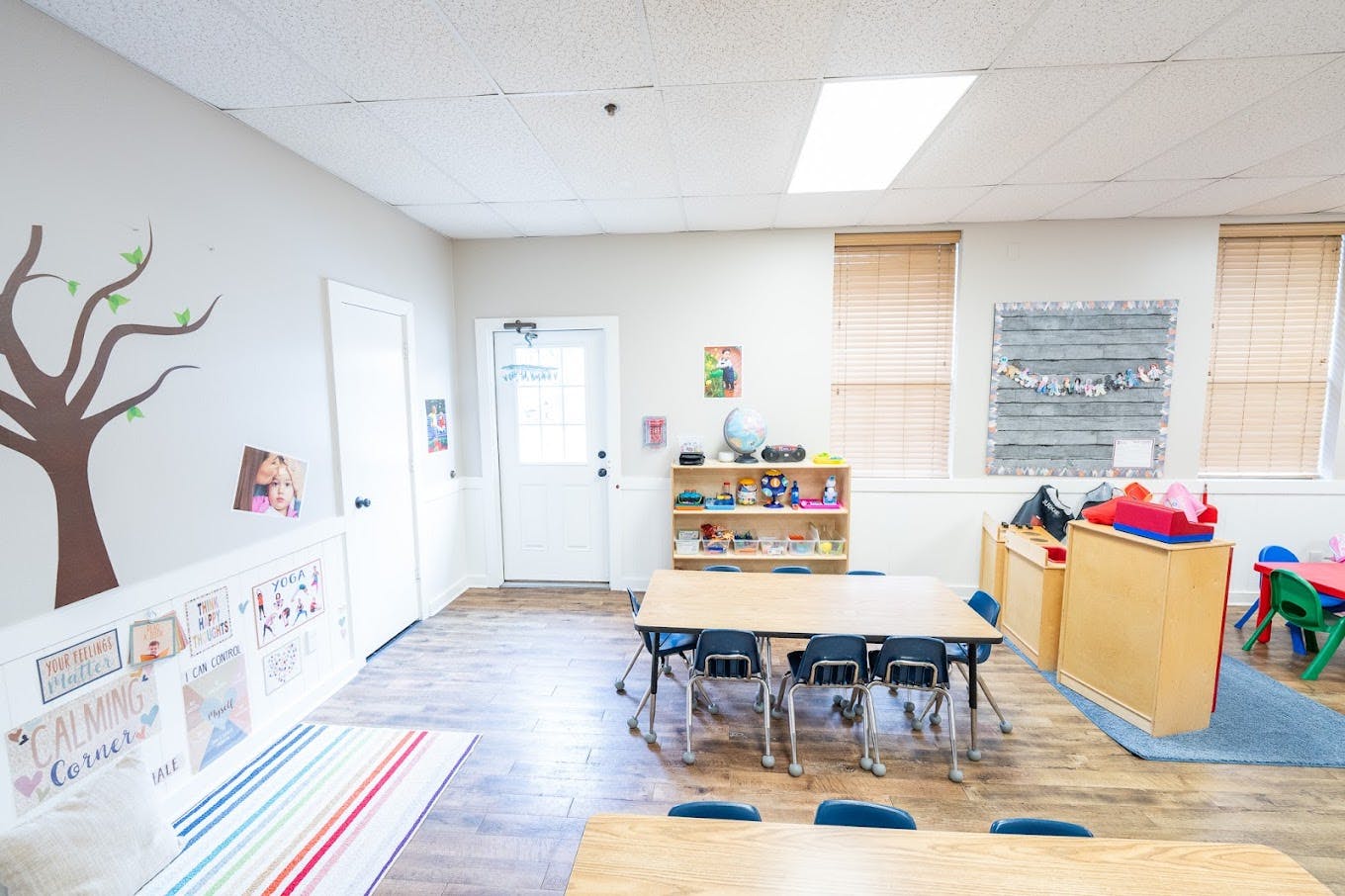 Classroom with tables, small chairs, and a calming corner area