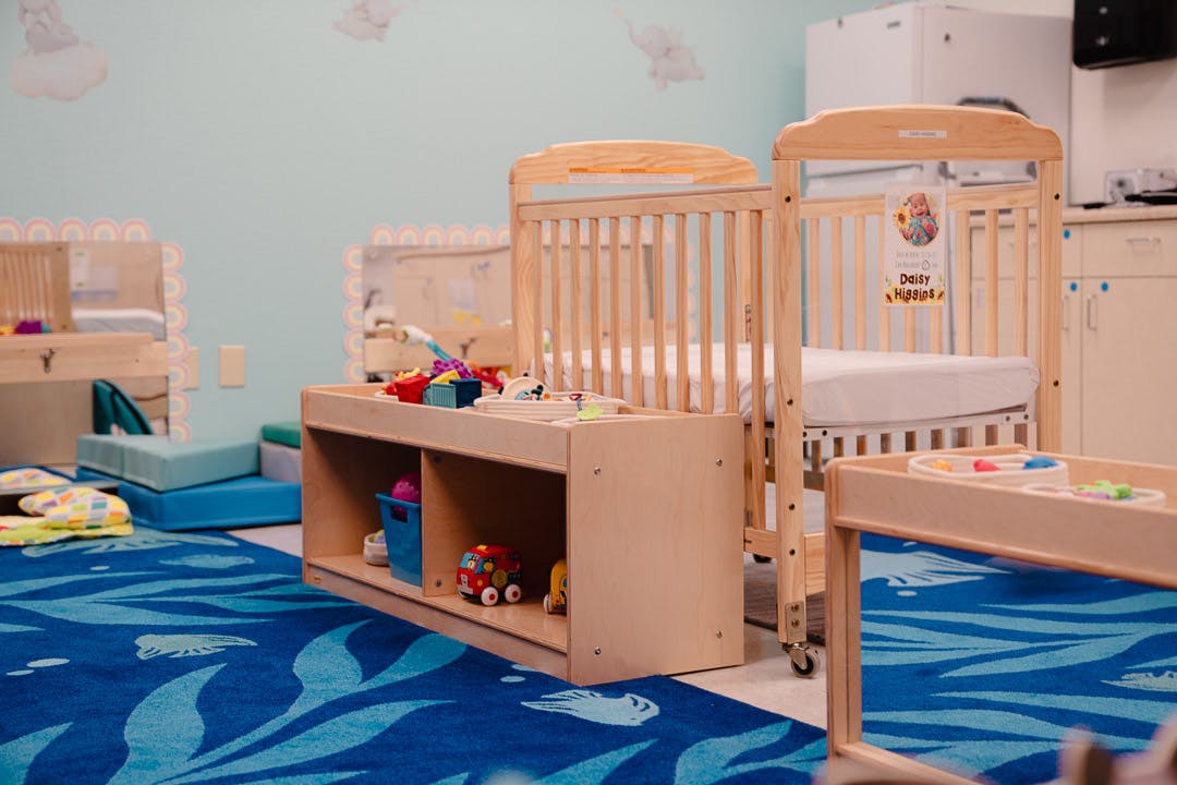 Cribs and toys in a childcare room