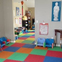 Playroom with colorful floor mats and small chairs