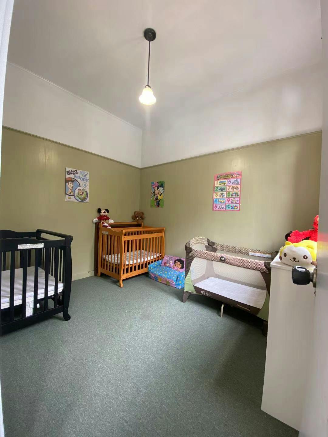 Room with three cribs and playards