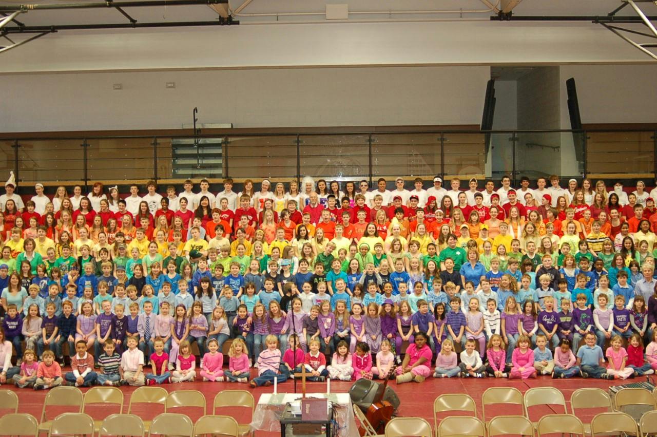 Large group of children posing for a photo in a gymnasium