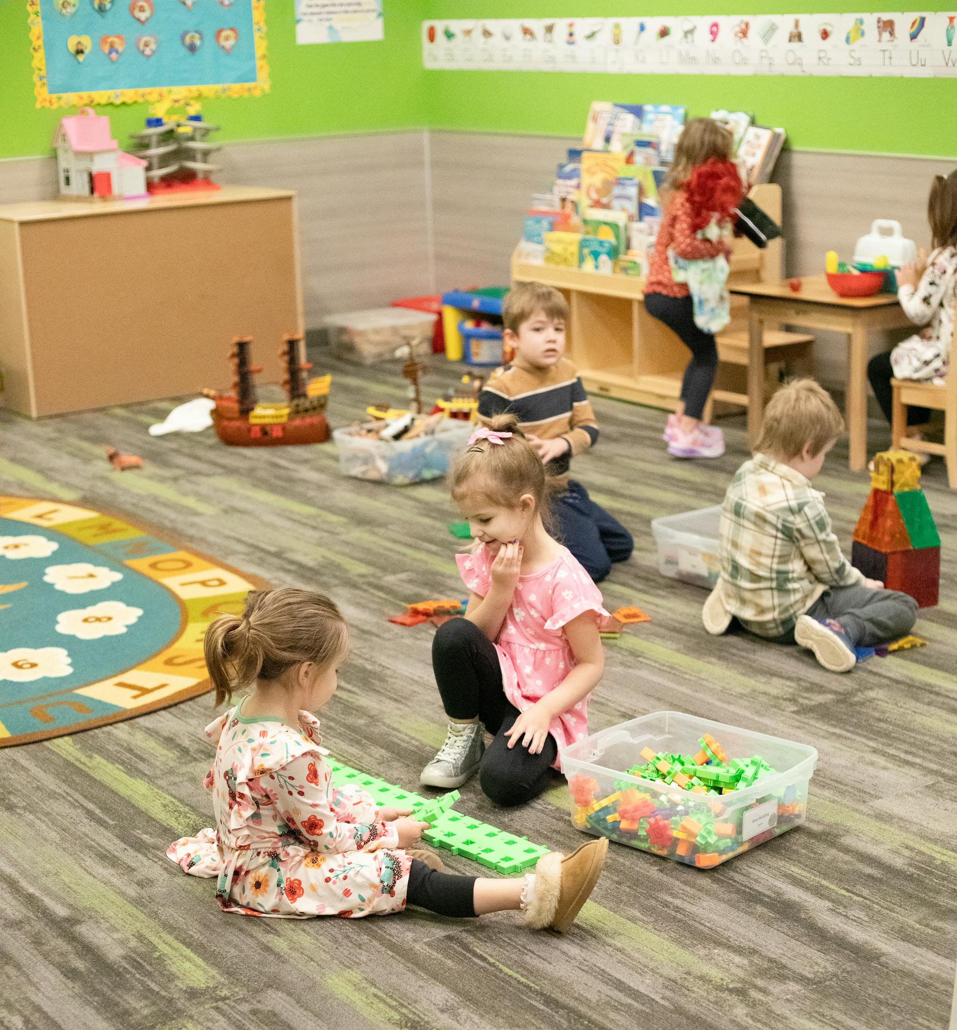 Children playing on the floor in a classroom