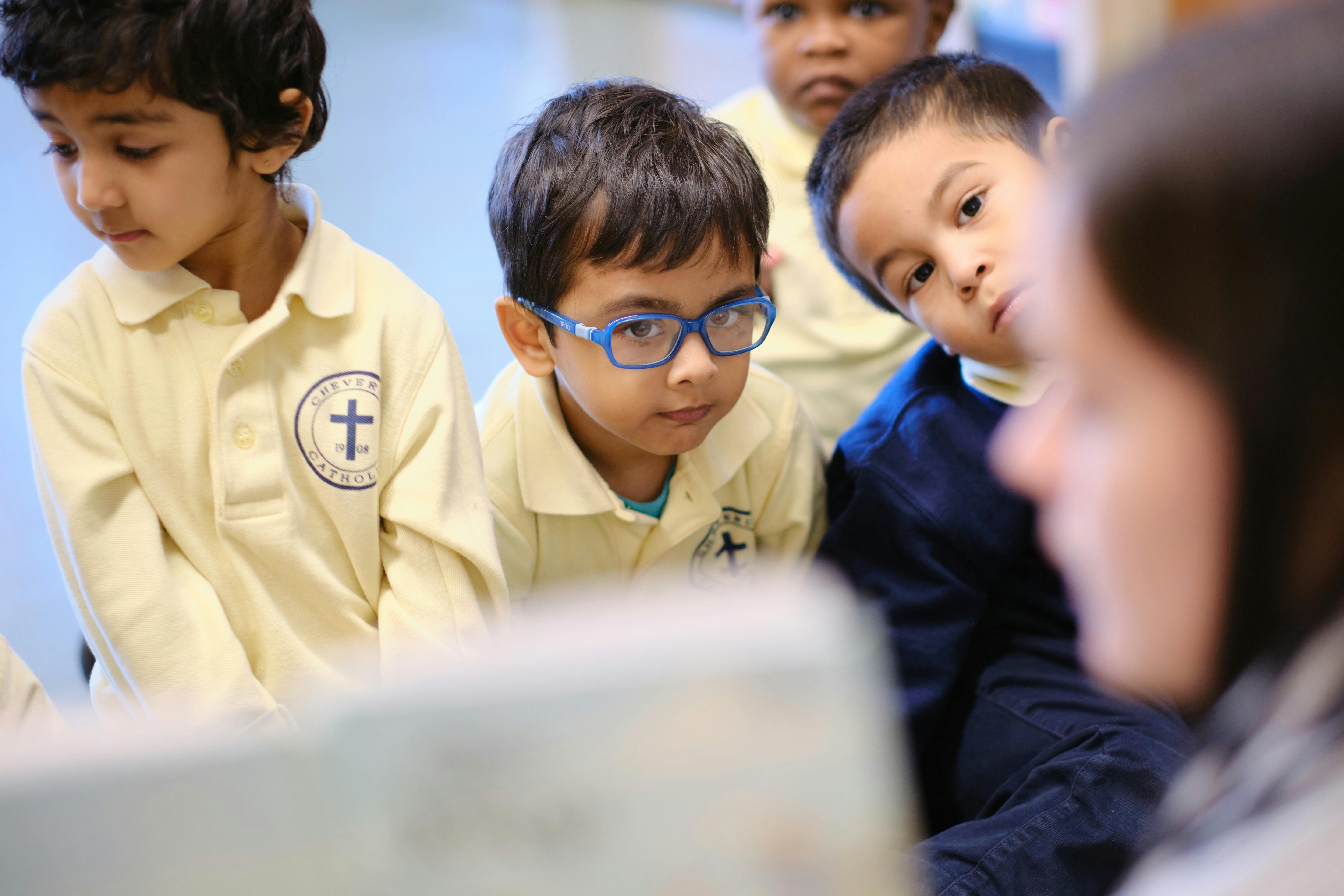 Children looking at a person in a classroom