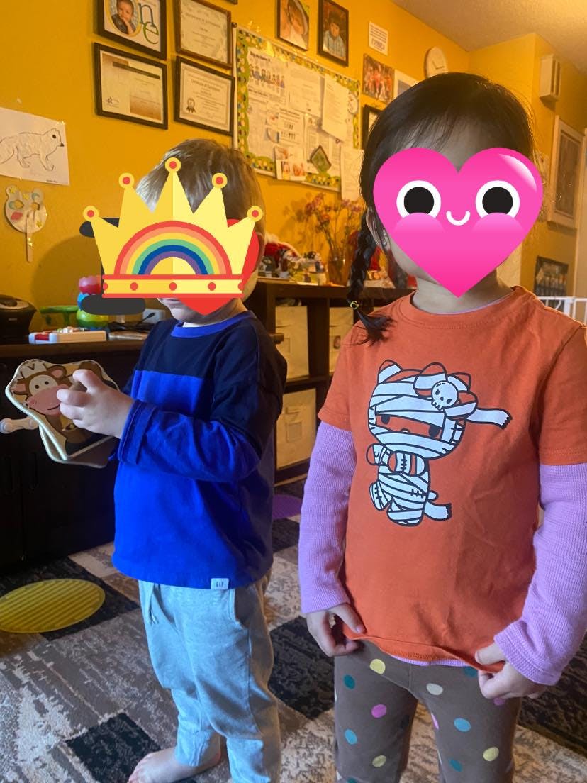 Two children standing indoors