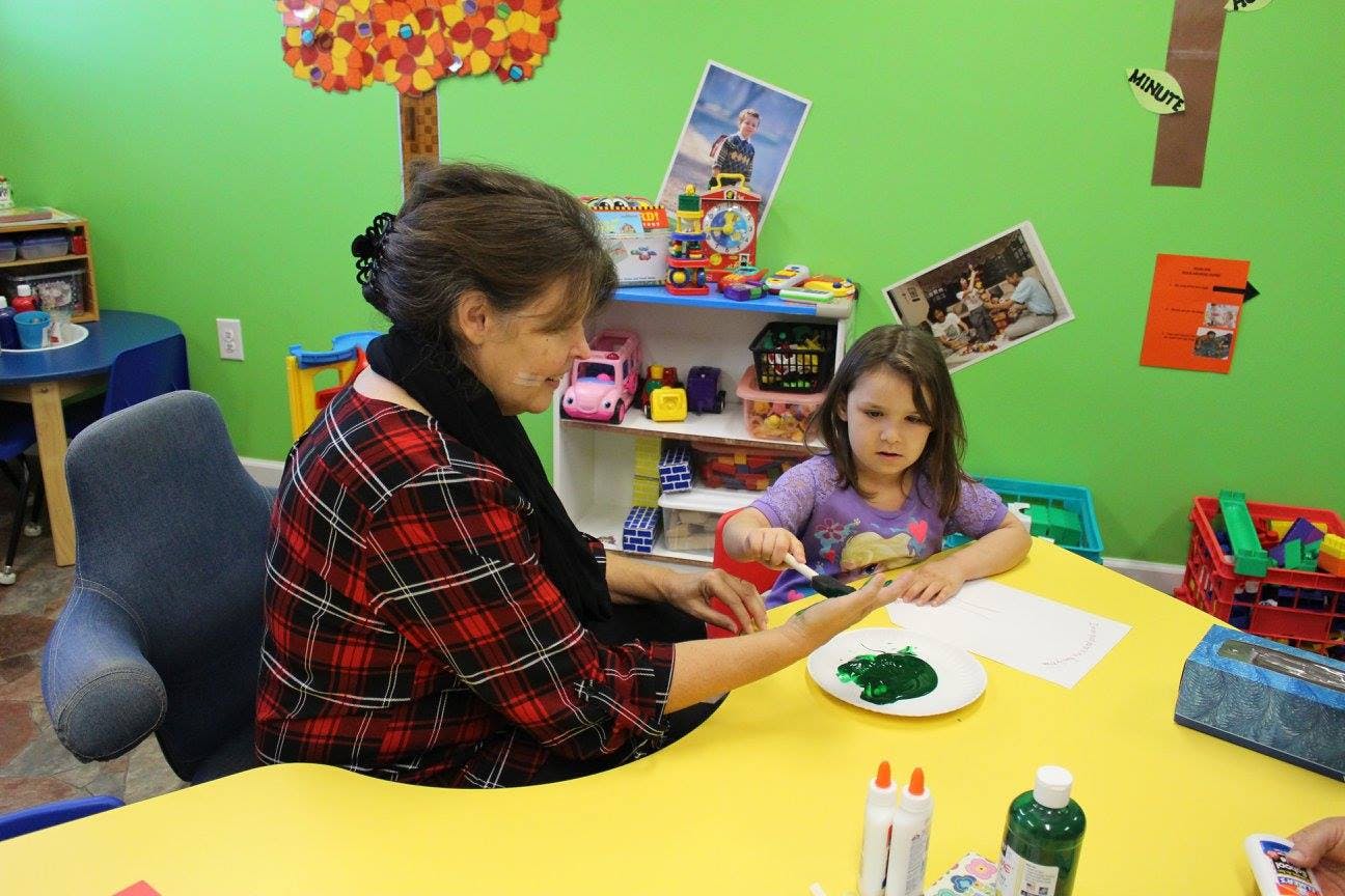 Adult and child doing an art project at a table