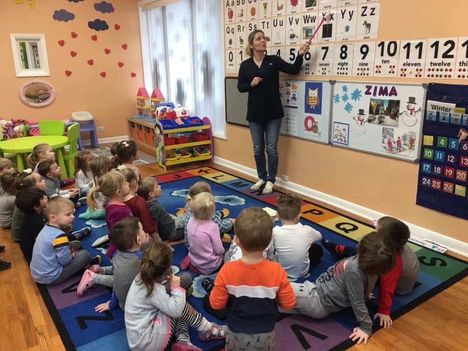 Person teaching children in a classroom