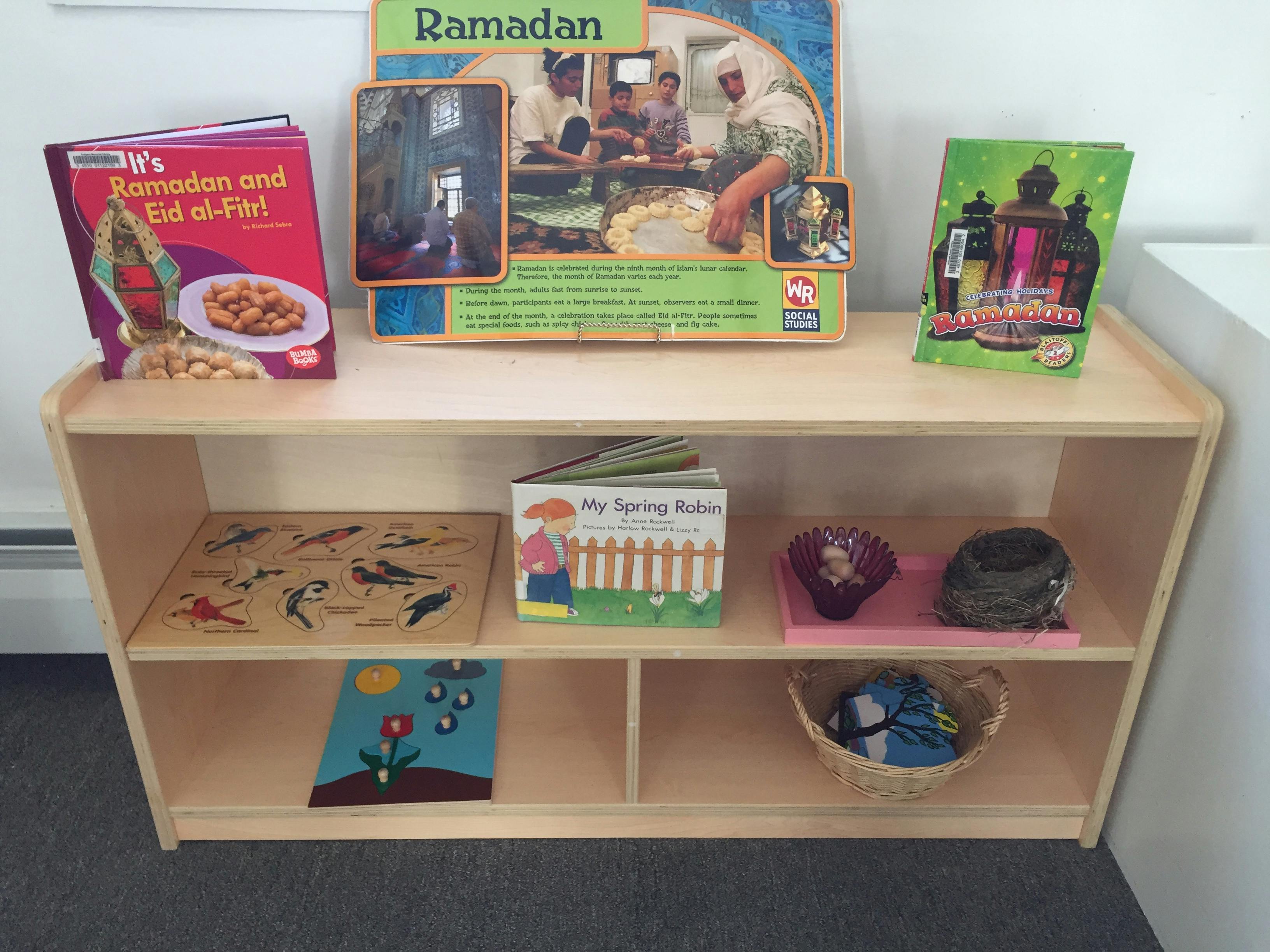 Books and learning materials on a wooden shelf