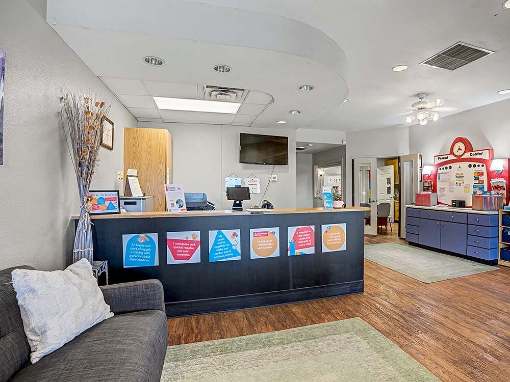 Lobby with a reception desk decorated with signs and a "Parent Center" display