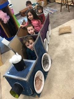 Children in a cardboard train