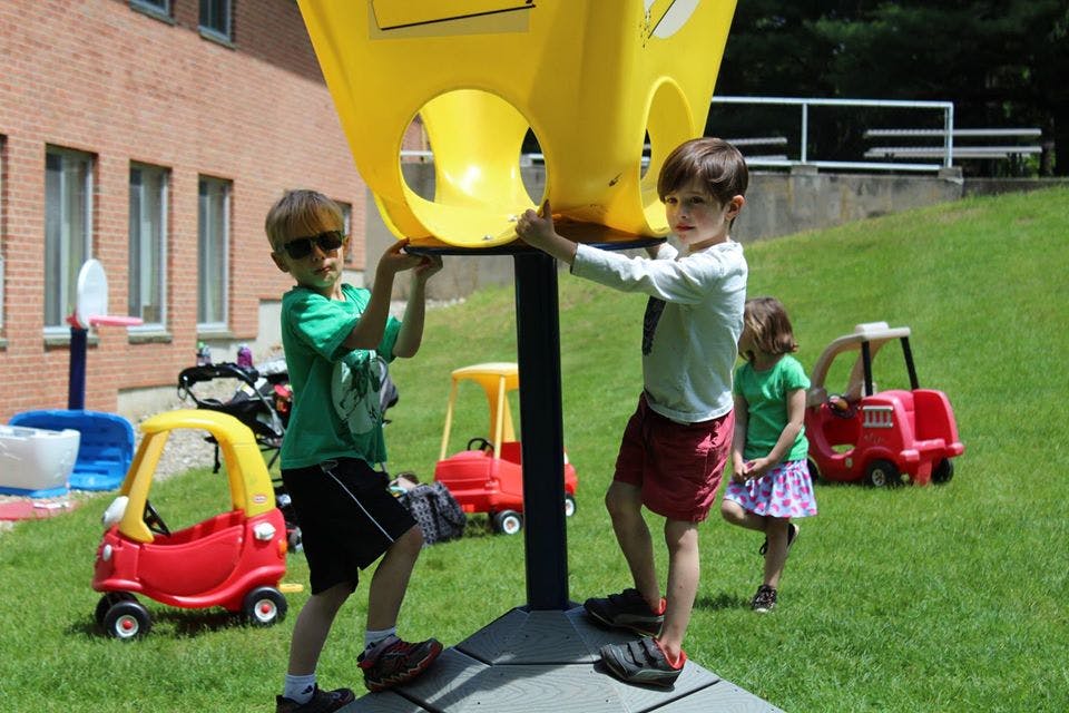 Children playing on a yellow playground structure