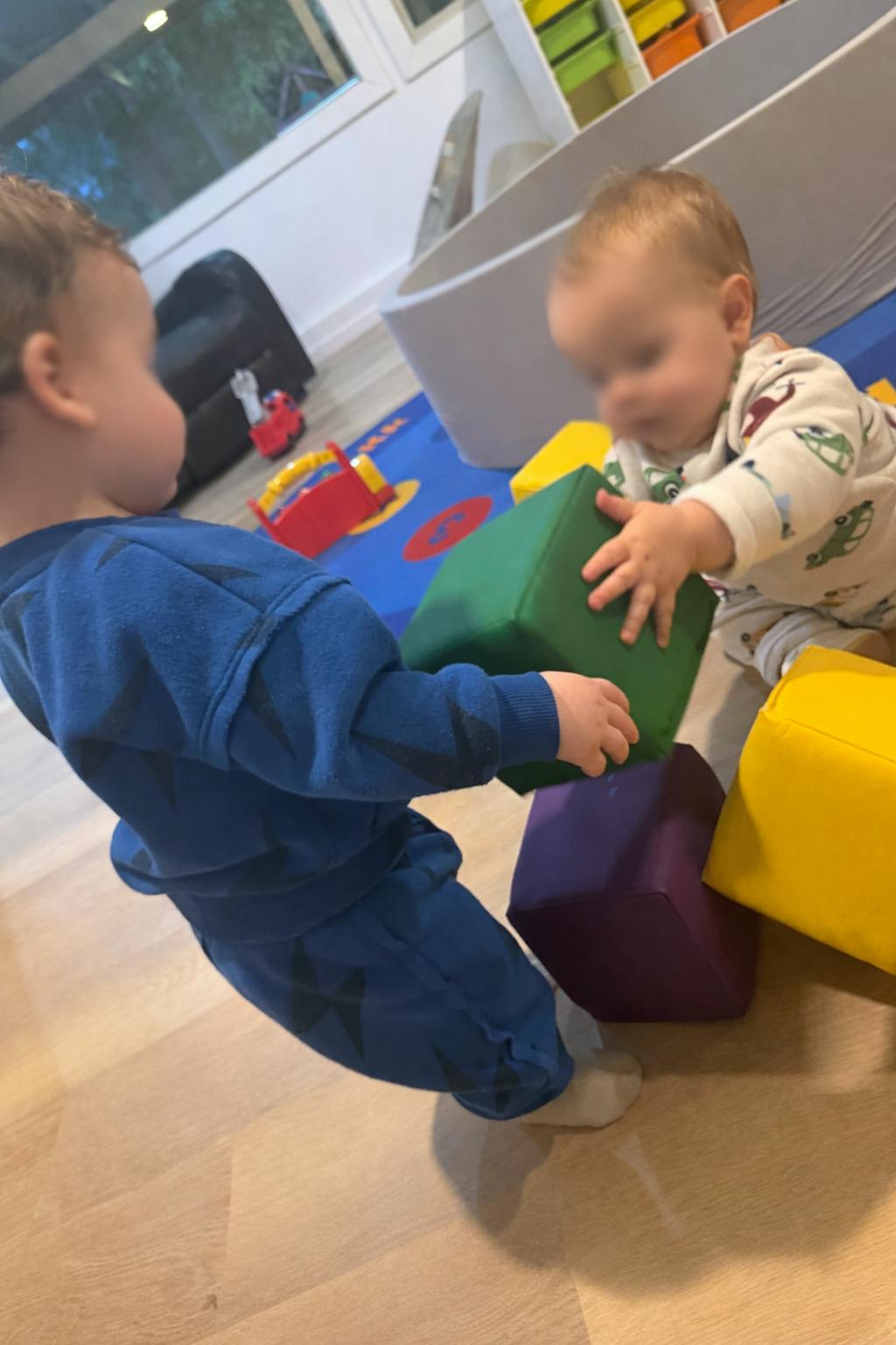 Two children playing with soft blocks