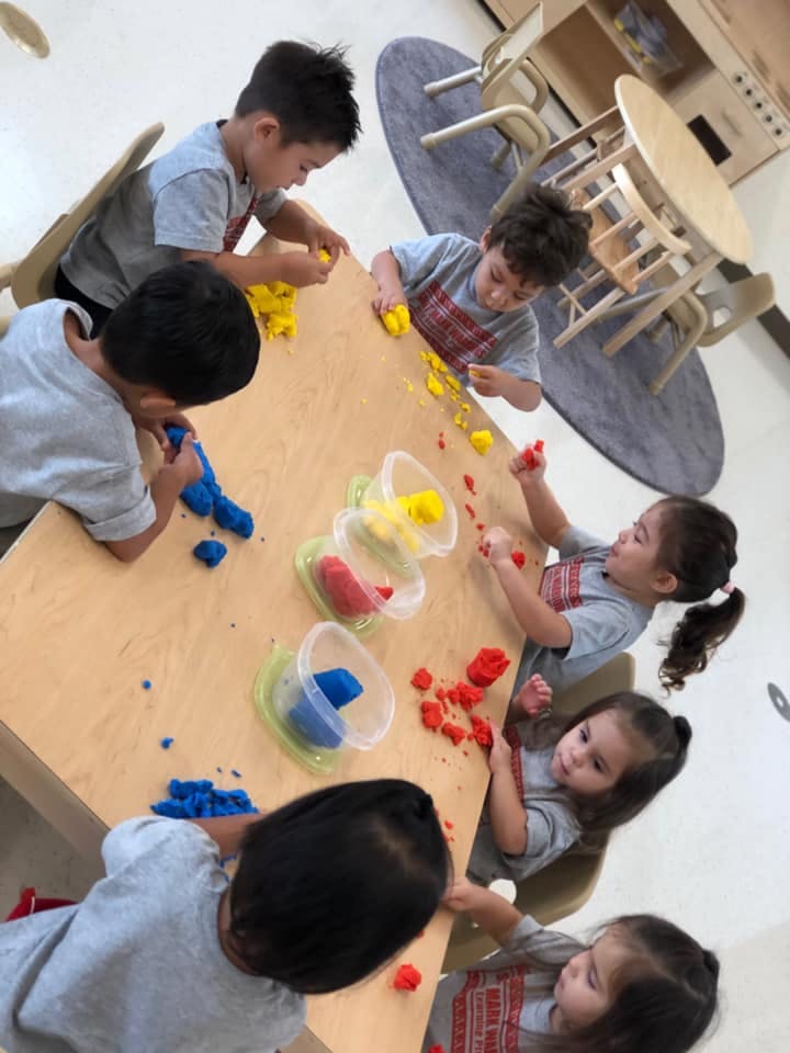 Children playing with colorful clay at a table