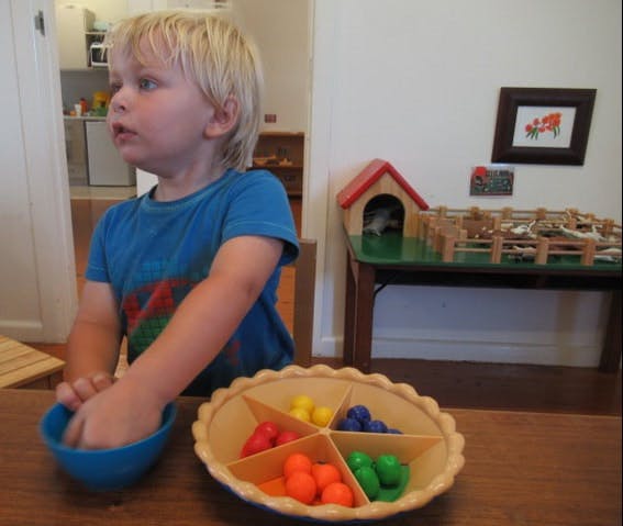 Child playing with colorful sorting game