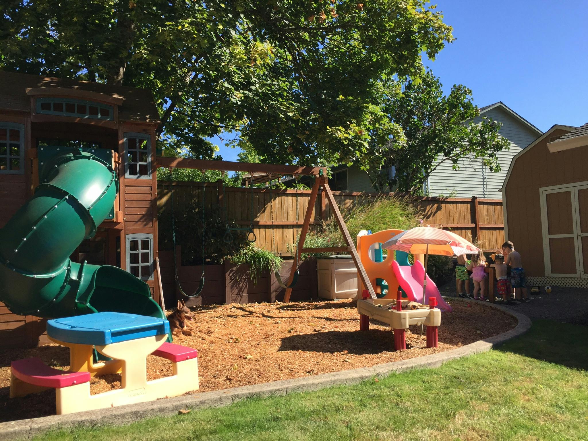 Playground with play structure, slide, swing set, and children