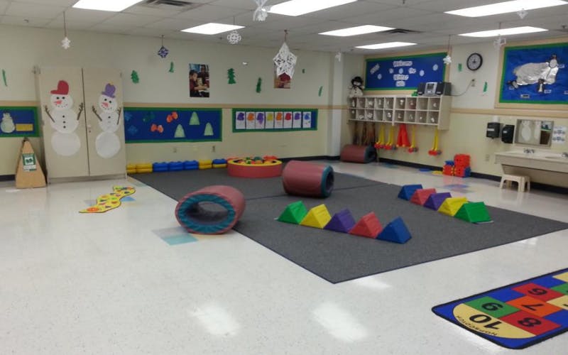Empty colorful children's play area with soft play equipment and small sinks