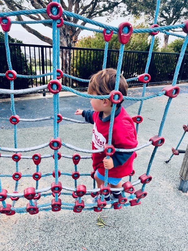 Child on a rope climbing structure