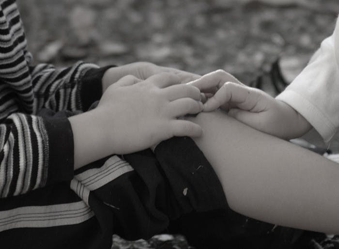 Two people's hands touching