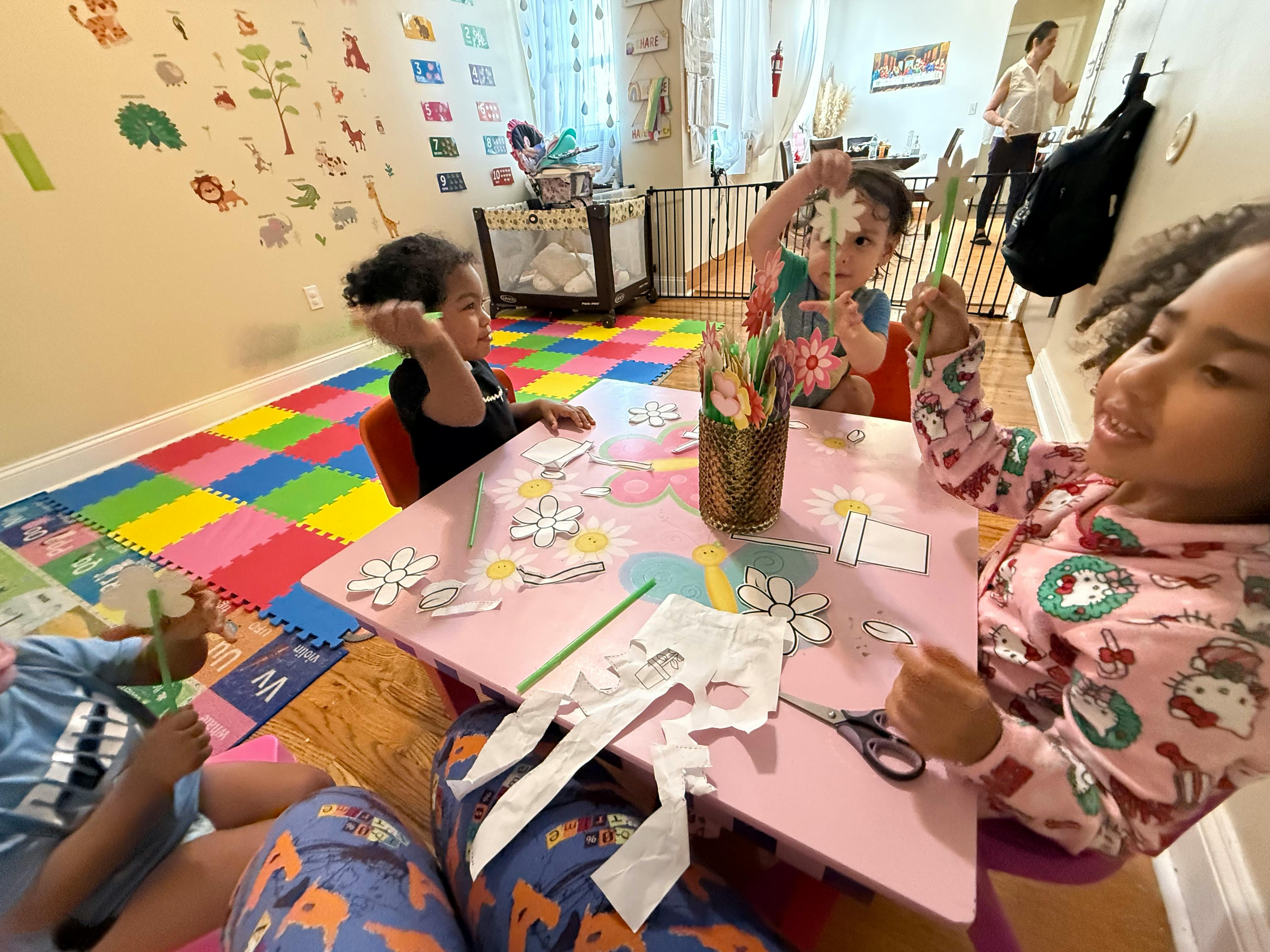 Children sitting at a table with craft supplies