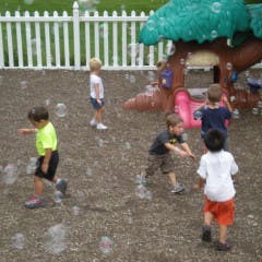 Children playing with bubbles outdoors