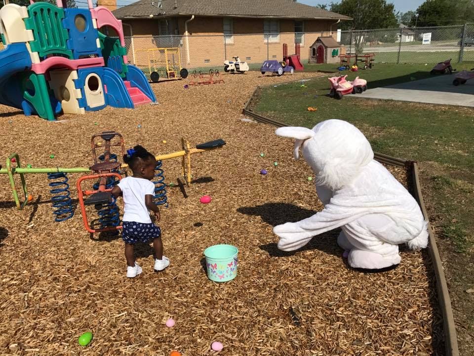 Child and person in bunny costume on playground