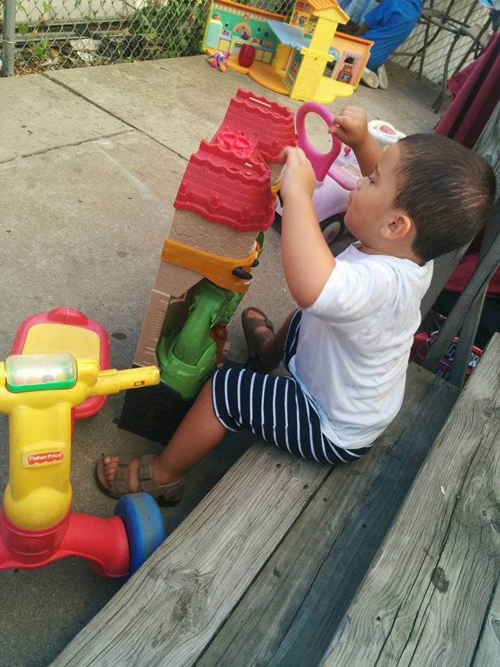 Child playing with a toy house