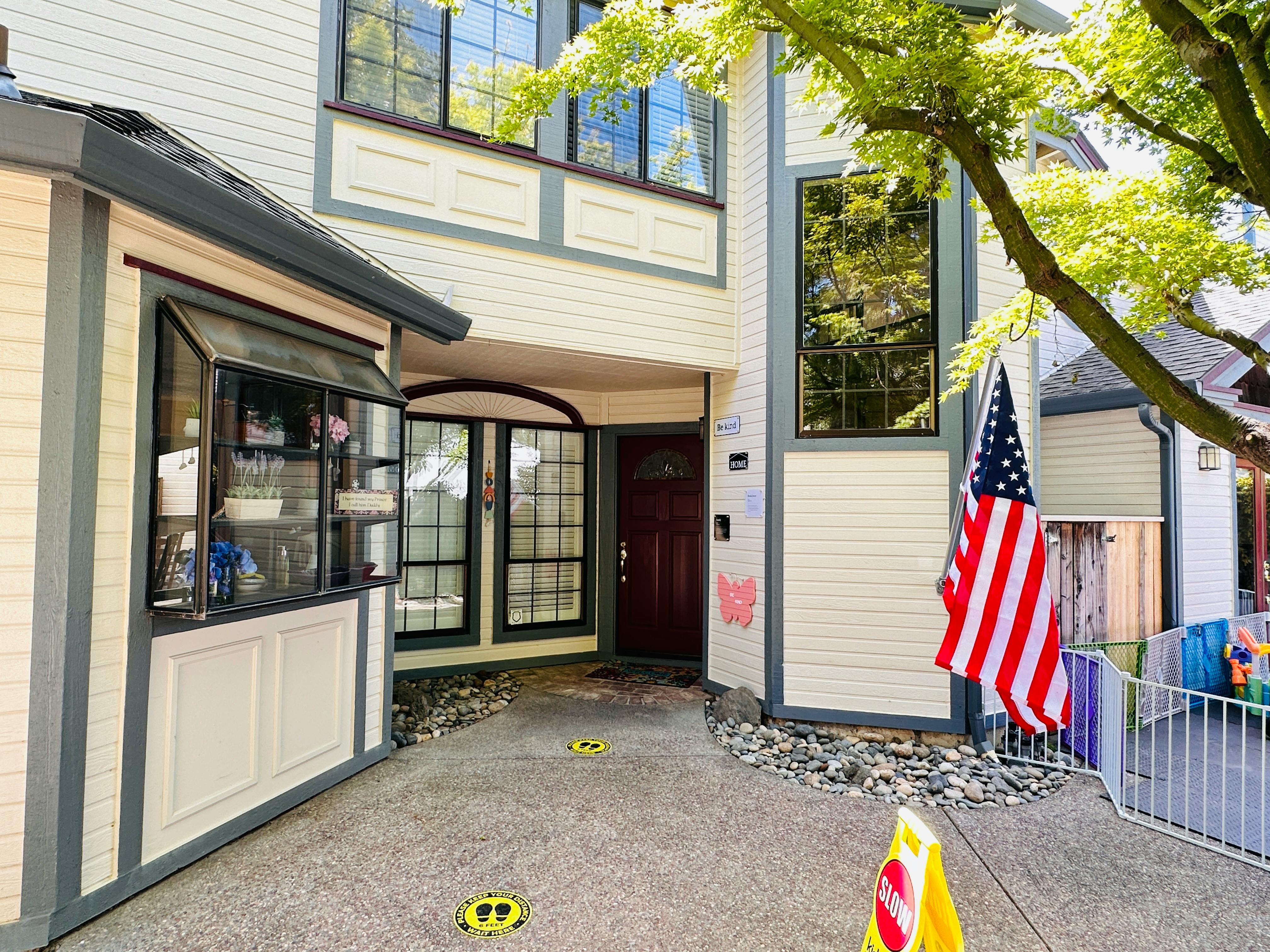 Exterior of a building with a window, door, and American flag