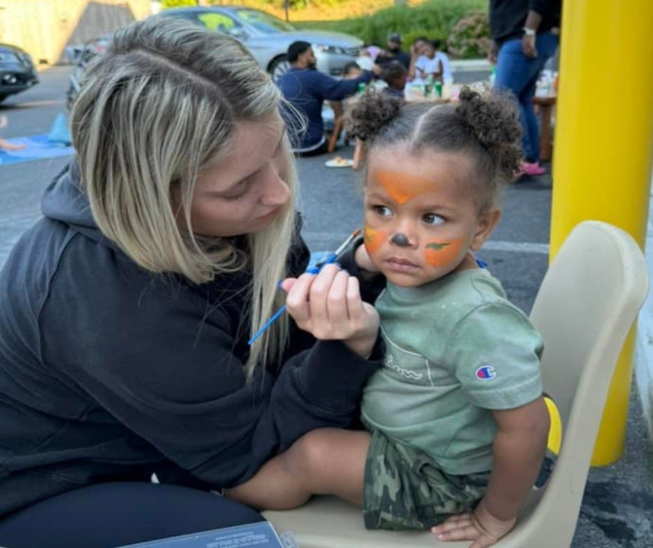 Person painting a child's face