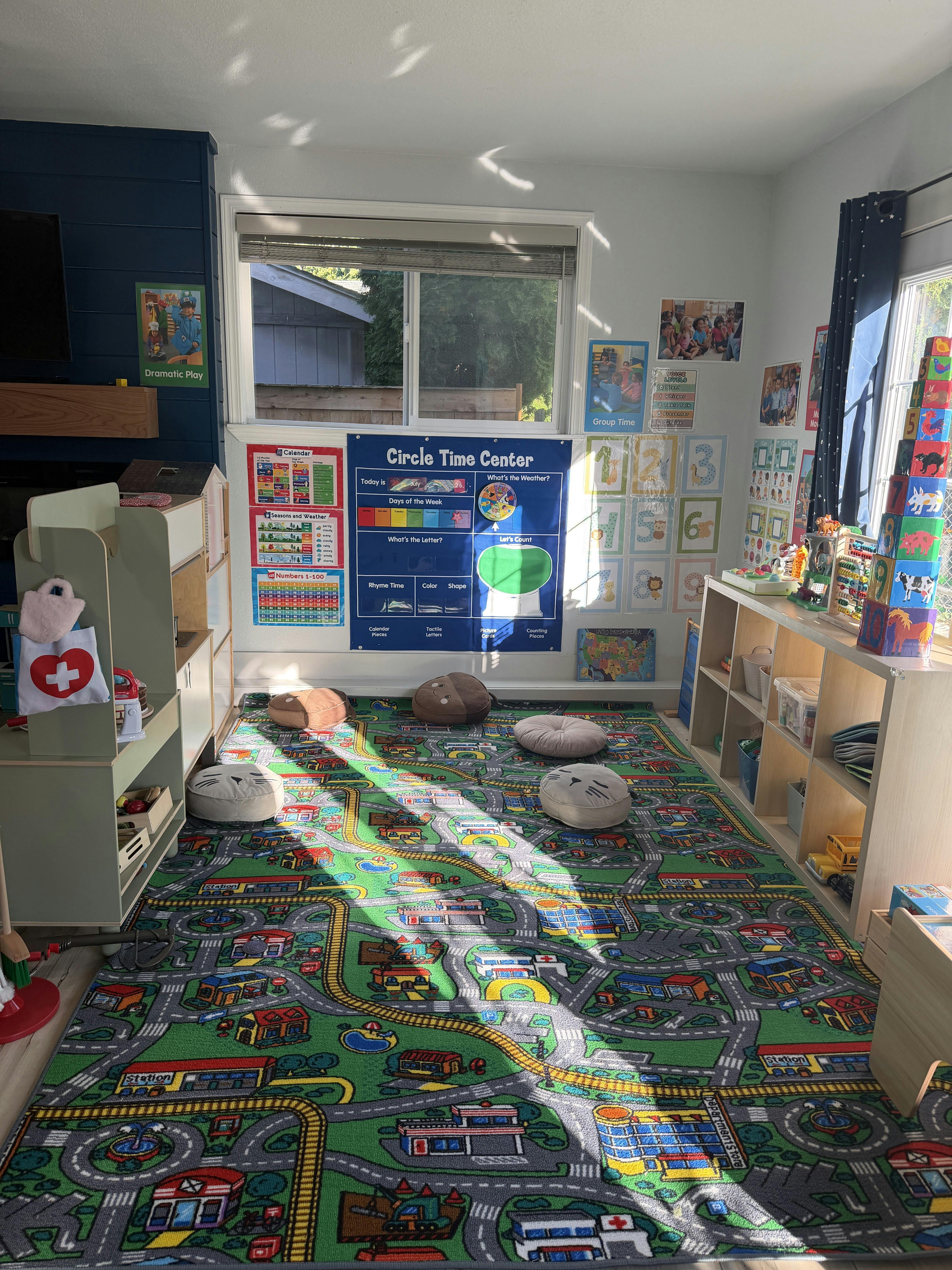 Classroom interior with educational wall charts and a road map play rug