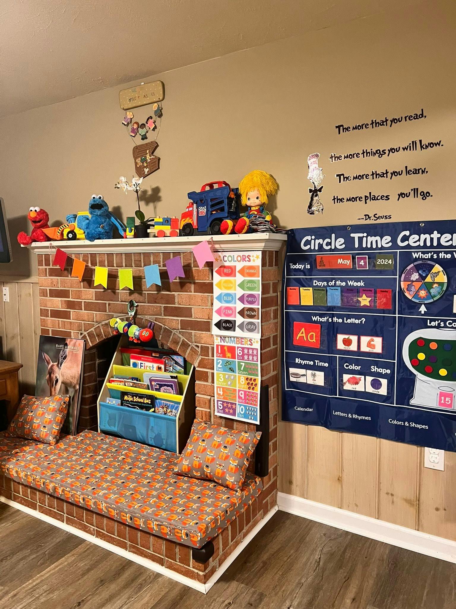 Playroom with a brick fireplace, toys, and educational charts