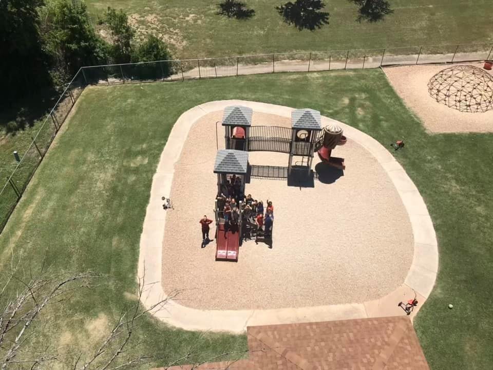Aerial view of a playground with multiple structures and children playing