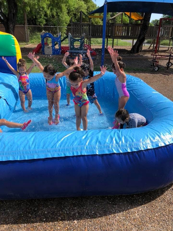 Children playing in an inflatable pool